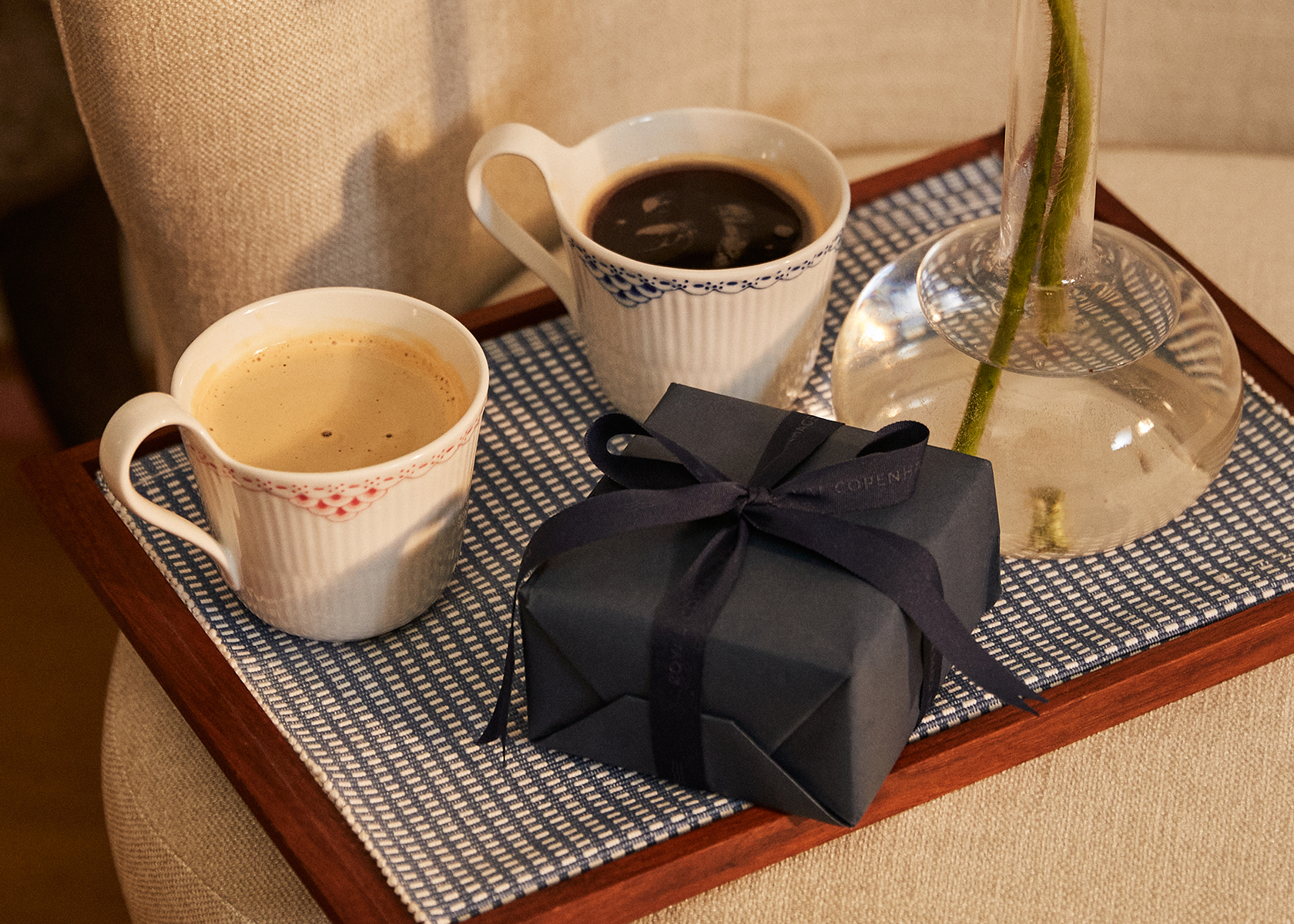 Coffee and a gift on a morning tray